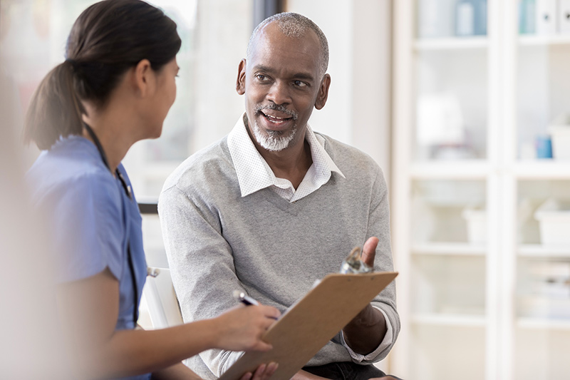 man talking to woman medical professional