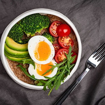 Balanced Meal Bowl With Egg, Avocado, Broccoli, and Tomatoes
