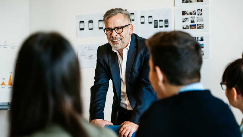 Mature businessman speaking at an informal meeting