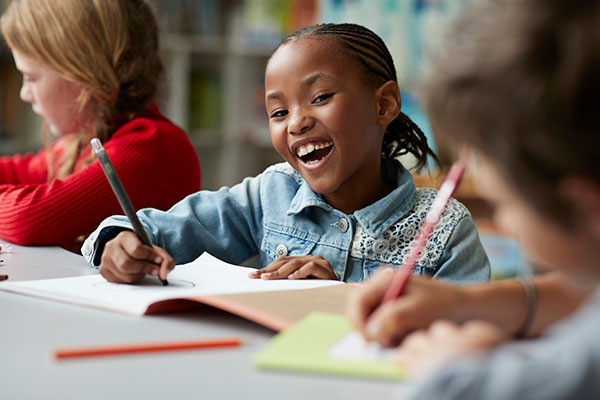 Student smiling at desk Student smiling at desk