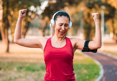 Woman celebrating while outside walking