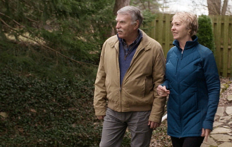 Gail Hogan and her husband walk outdoors Gail Hogan and her husband walk outdoors