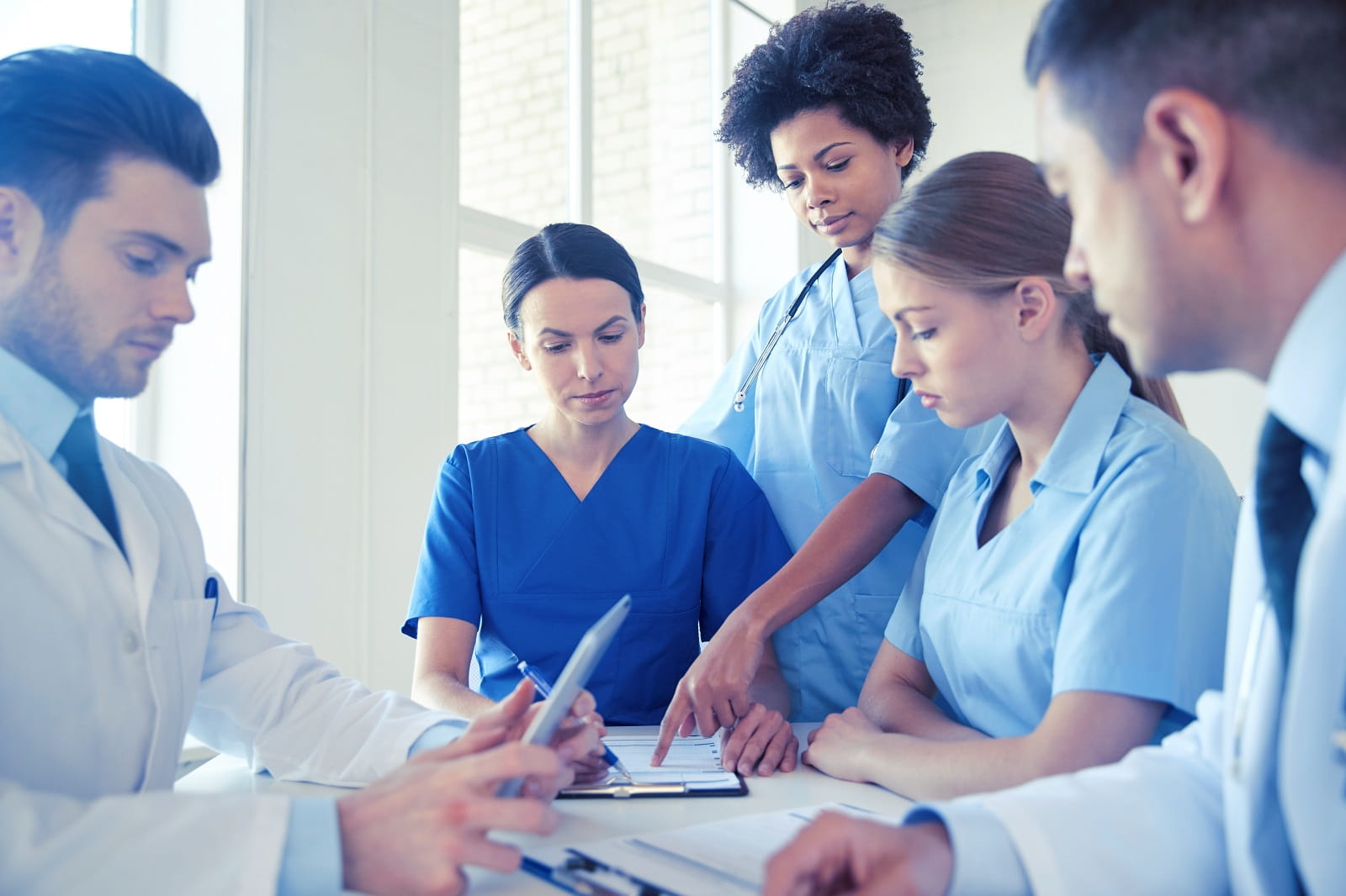 stock photo of group of medical workers looking at data