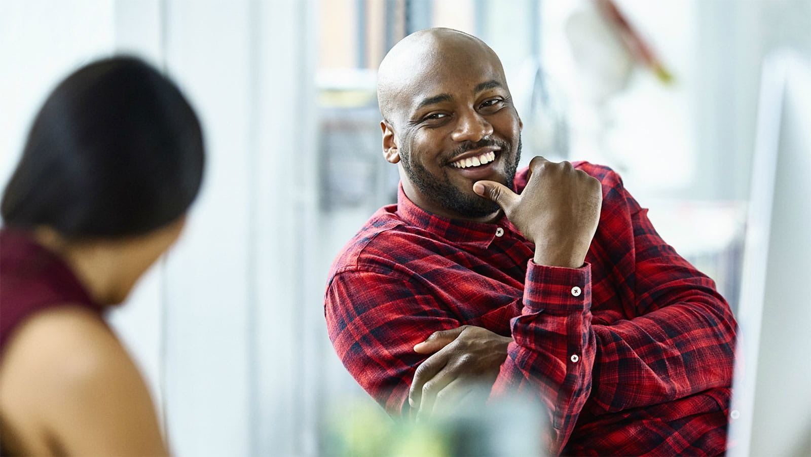 Smiling man making conversation in an office setting